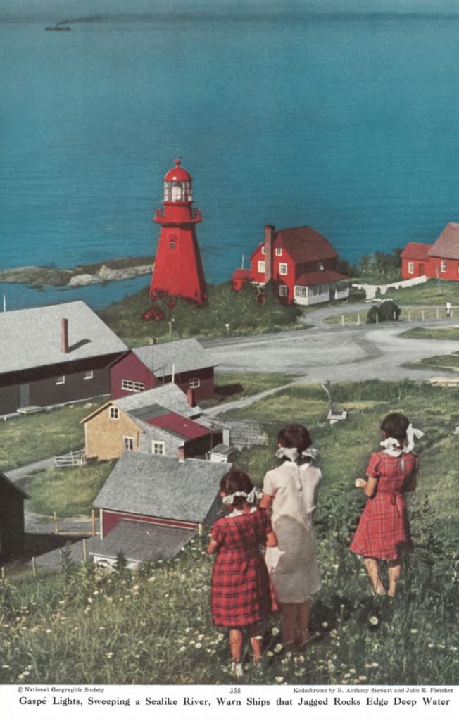 Three girls in plaid dresses looking over their coastal town. 